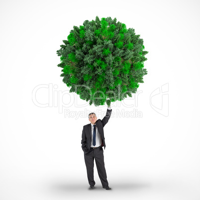 Composite image of businessman holding green sphere