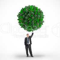 Composite image of businessman holding green sphere