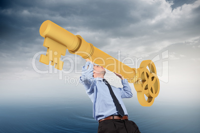 Composite image of businessman carrying large key