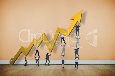 Composite image of business team holding up arrow