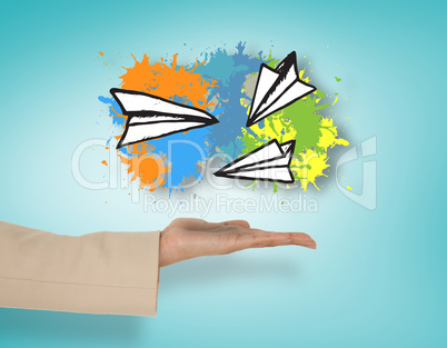Composite image of female hand presenting paper airplanes