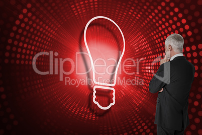 Composite image of light bulb and businessman looking