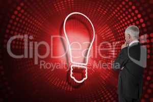 Composite image of light bulb and businessman looking