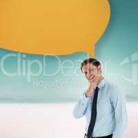 Composite image of thoughtful businessman with speech bubble wit