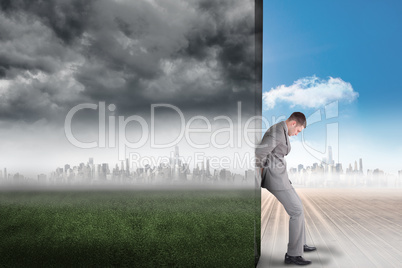 Composite image of businessman pushing away scene