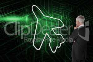 Composite image of airplane and businessman watching