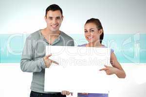 Composite image of attractive young couple showing card