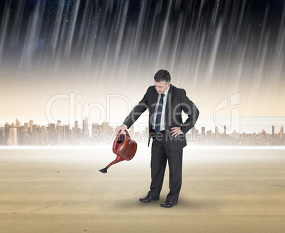 Composite image of mature businessman using watering can