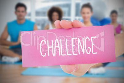 Woman holding pink card saying challenge