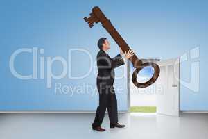 Composite image of stressed businessman carrying large key