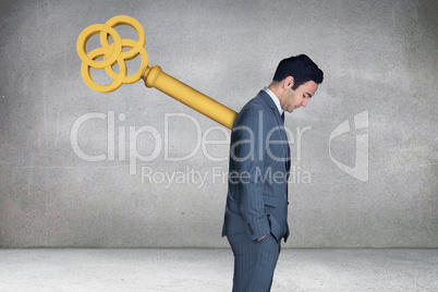 Composite image of wound up businessman with hands in pockets