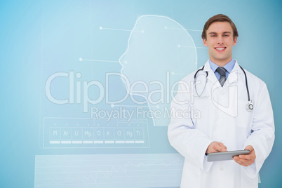 Composite image of young doctor using tablet pc Composite image of young doctor using tablet pc