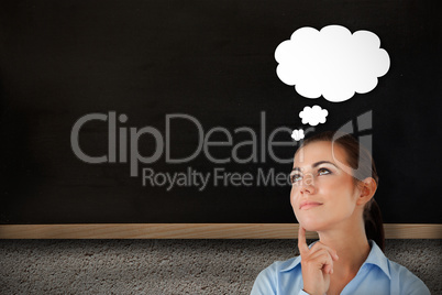 Composite image of thinking businesswoman looking upwards