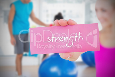 Fit blonde holding card saying strength