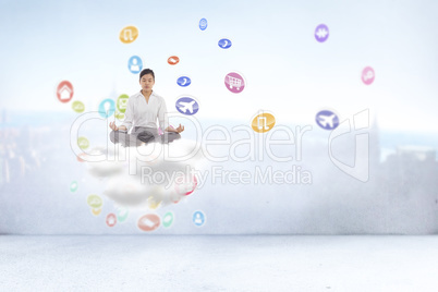 Composite image of businesswoman sitting in lotus pose