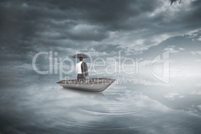 Composite image of businessman standing back to camera in a sail