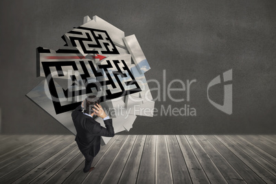 Composite image of stressed businessman with hands on head