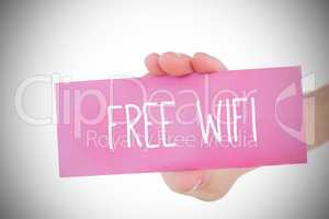 Woman holding pink card saying free wifi