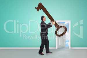 Composite image of stressed businessman carrying large key