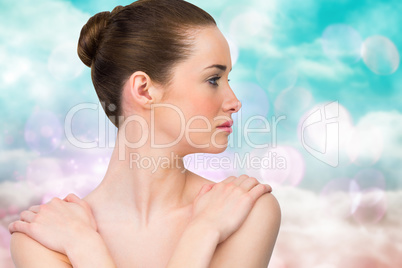 Composite image of beautiful brunette with arms over chest