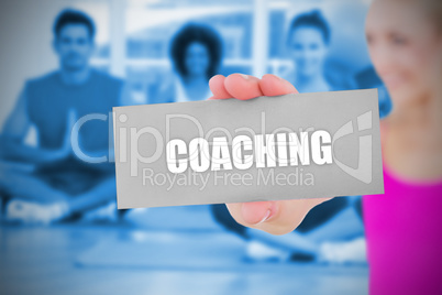 Fit blonde holding card saying coaching