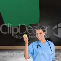 Composite image of happy surgeon holding an apple with speech bu