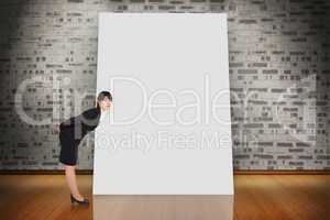 Composite image of serious businesswoman bending