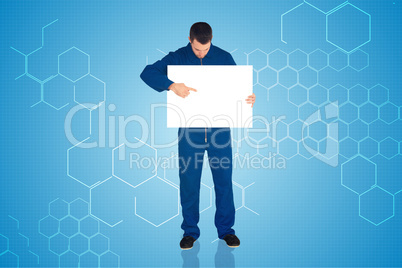 Composite image of handsome mechanic showing card