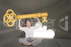 Composite image of businesswoman sitting cross legged carrying l