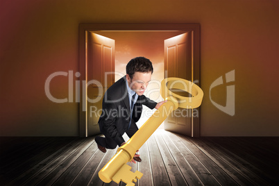 Composite image of businessman carrying large key