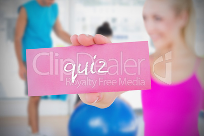 Fit blonde holding card saying quiz