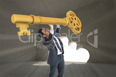 Composite image of stressed businessman carrying large key