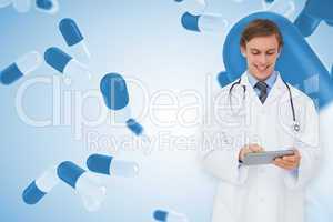 Composite image of young doctor using tablet pc
