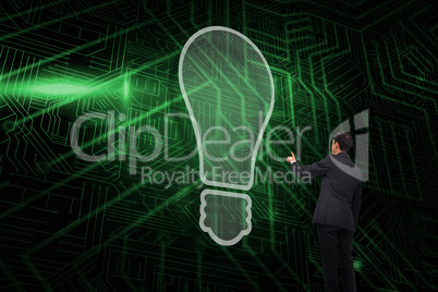 Composite image of light bulb and businessman pointing