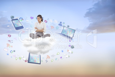 Composite image of grumpy businesswoman sitting cross legged