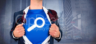 Composite image of businessman opening his shirt superhero style