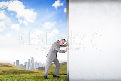 Composite image of businessman pushing away scene