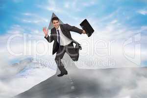 Composite image of cheerful businessman in a hurry