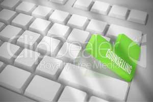 Counselling on white keyboard with green key