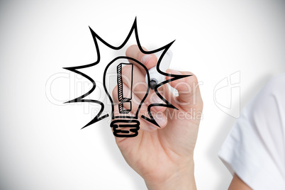 Composite image of businesswoman drawing light bulb