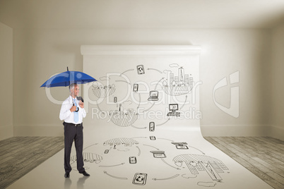 Composite image of happy businessman holding umbrella