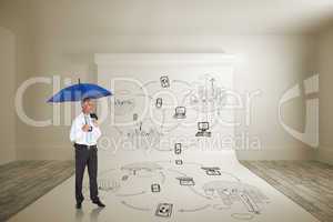 Composite image of happy businessman holding umbrella