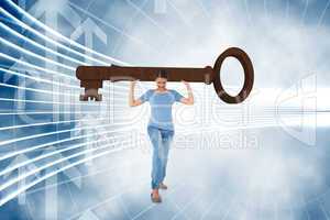 Composite image of annoyed brunette carrying large key