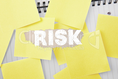 Risk against sticky notes strewn over notepad