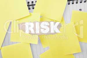 Risk against sticky notes strewn over notepad