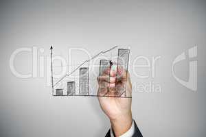 Composite image of businessman drawing graph