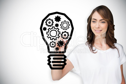 Composite image of businesswoman drawing light bulb