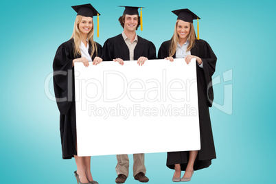 Composite image of college graduates showing card