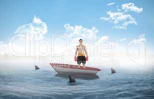 Composite image of boxer standing in a sailboat