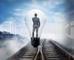 Composite image of thinking businessman in light bulb